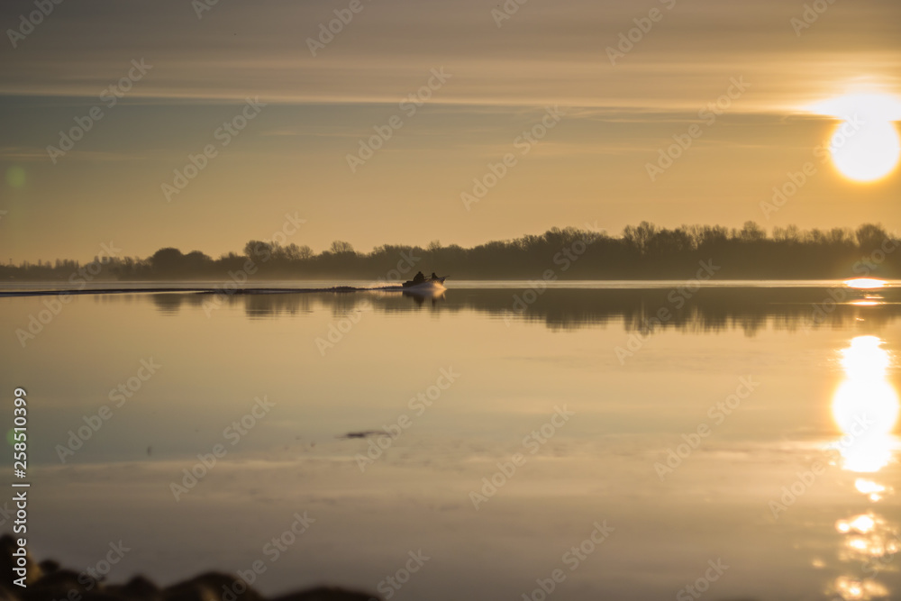  Boat on the river at sunset.