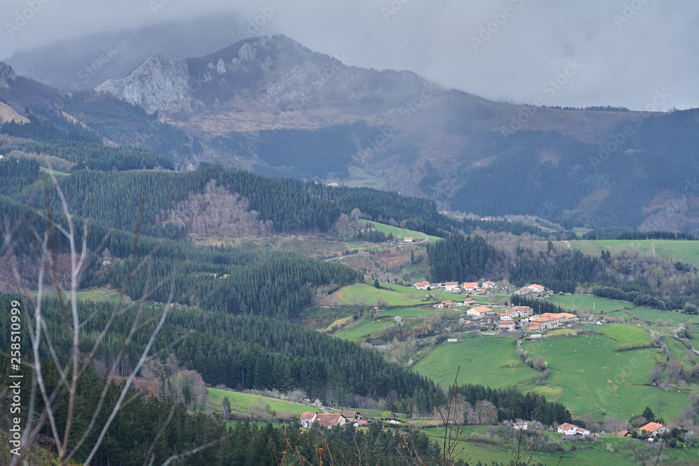 Beautiful landscape with mountain, green fields and rural village in the Basque Country, Spain. The little Swiss