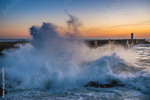 Large waves on Atlantic Ocean during sunset in Porto, Portugal