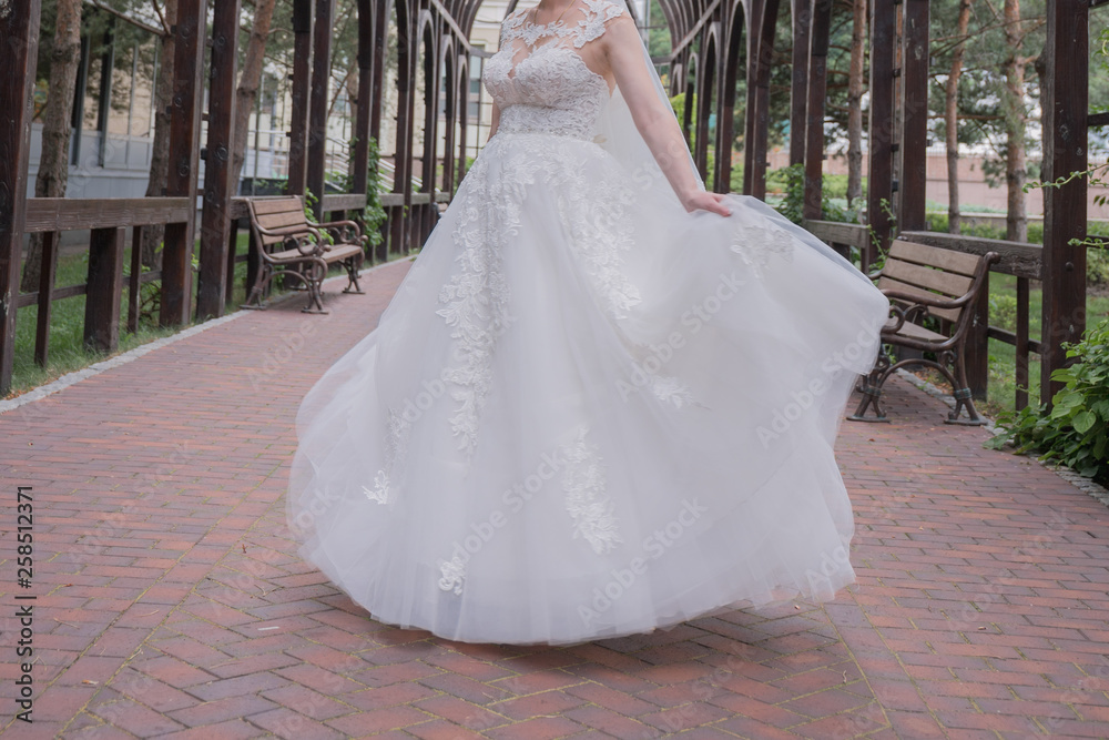 bride in wedding dress whirls in the park bride in wedding dress whirls in the park