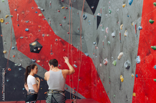 young attractive girl and handsome man discussing bouldering process. copy space