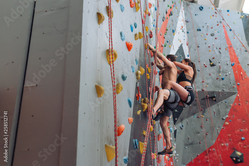 amazing activity for active and ambitious young people. professional climbers are working out at fitness center. full length side view photo. copy space