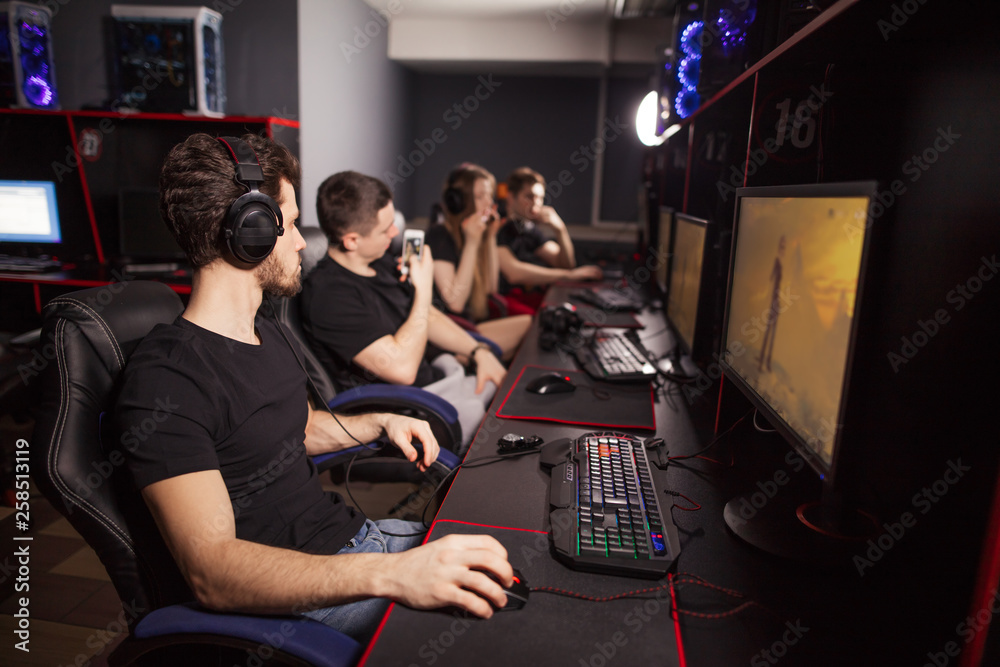 Casual gamers and hardcore fans are gather together in pc gaming club to  compete in playing MMO Games online Tournament Stock Photo | Adobe Stock