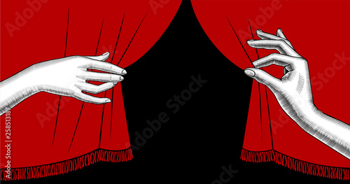 Female hands pulling aside the red curtain on black background