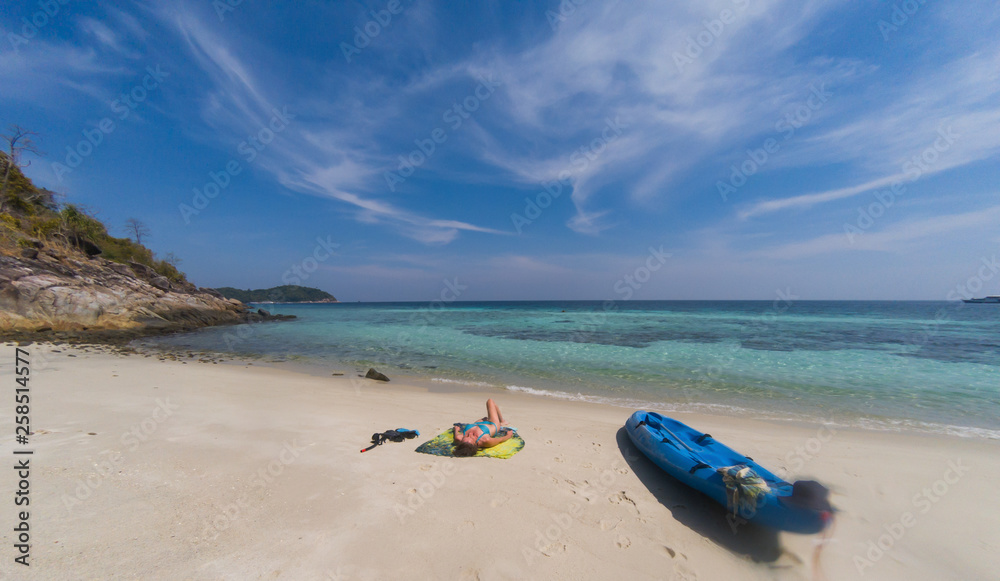 woman with a kayak on an isolated beach in Andaman sea, Koh Lipe - solo travel