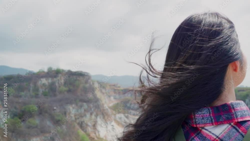 Slow motion - Hiker Asian backpacker woman on top of mountain, Female enjoy her holidays on hiking adventure feeling freedom. Lifestyle women travel and relax in free time concept. Slow motion - Hiker Asian backpacker woman on top of mountain, Female enjoy her holidays on hiking adventure feeling freedom. Lifestyle women travel and relax in free time concept.