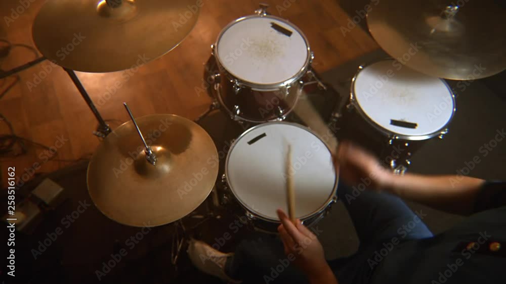 male drummer, a lesson of jazz training on the drum set in the rehearsal room
