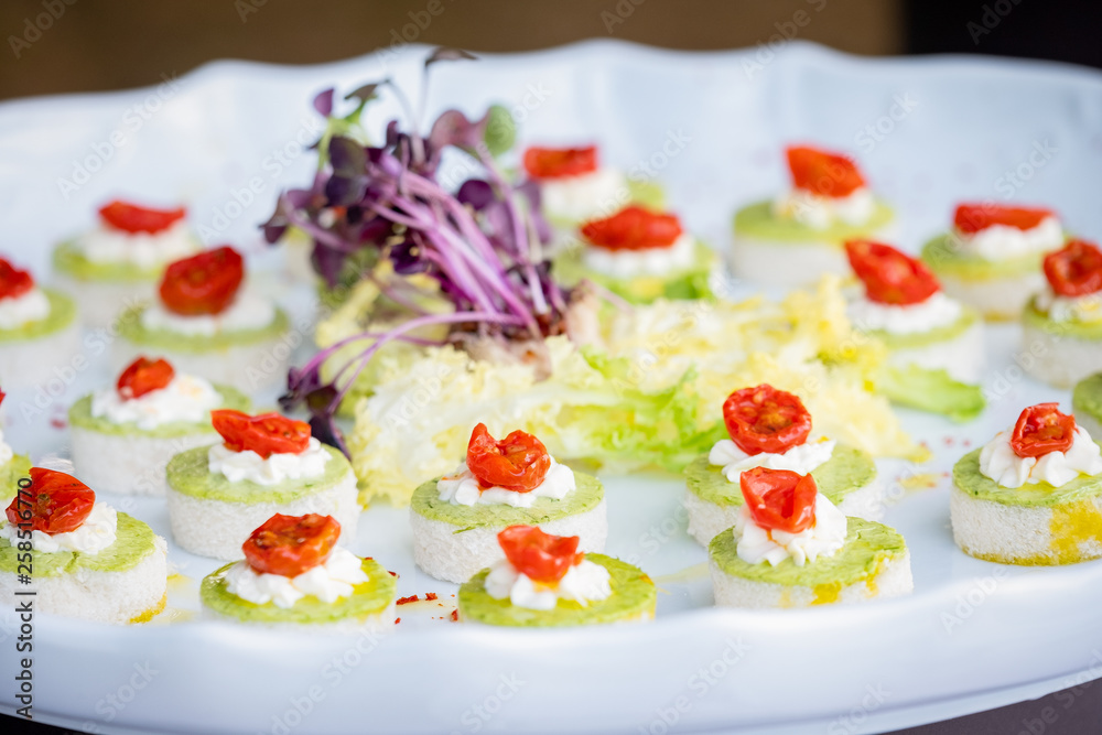 Finger food with dried tomatoes and green sauce Finger food with dried tomatoes and green sauce