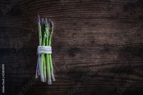 bunch of green asparagus on rustic wooden table flat lay 