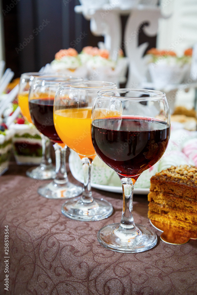 Naklejka premium glass goblets with red and orange juice