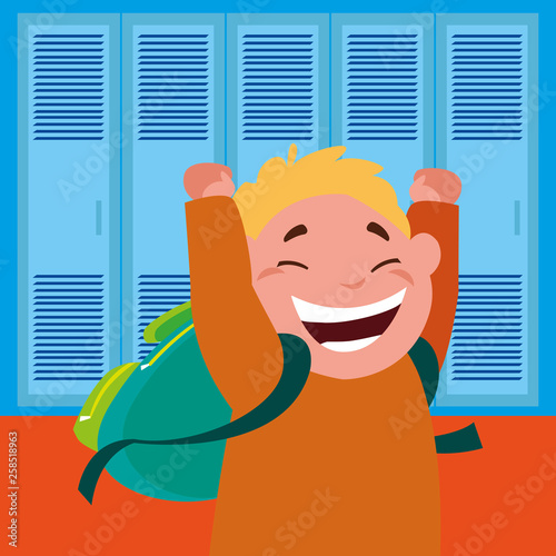 little schoolboy with schoolbag in school corridor