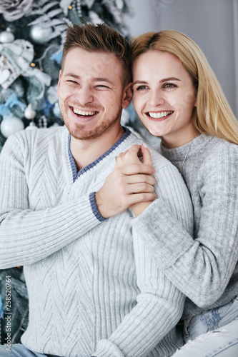 Love story in studio near Christmas tree