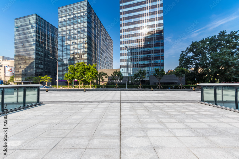 Panoramic skyline and modern business office buildings with empty road,empty concrete square floor Panoramic skyline and modern business office buildings with empty road,empty concrete square floor
