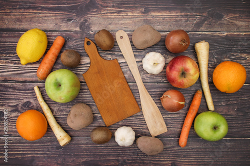 Cutting board and wooden spoon with fruits and vegetables for vegetarian