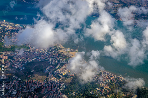 Aerial view from airplane window on Lisbon city over Tagus river, Portugal