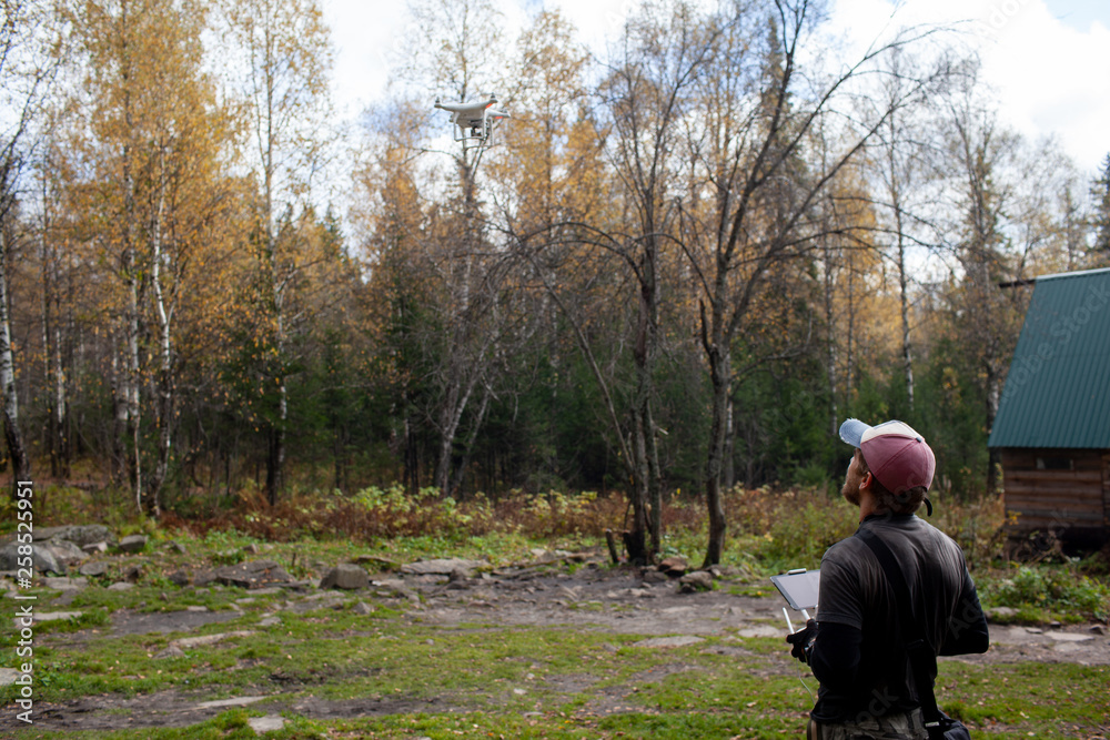 Male tourist exploring new places. Handsome bearded man on nature with fuel. Using drone photographs and shoots nature Male tourist exploring new places. Handsome bearded man on nature with fuel. Using drone photographs and shoots nature