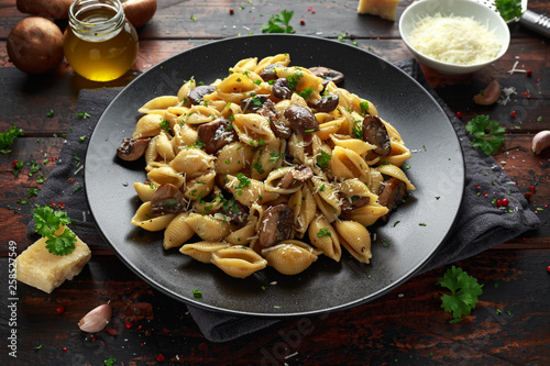 Carbonara mushrooms pasta Conchiglie with creamy sauce, parmesan cheese and herbs