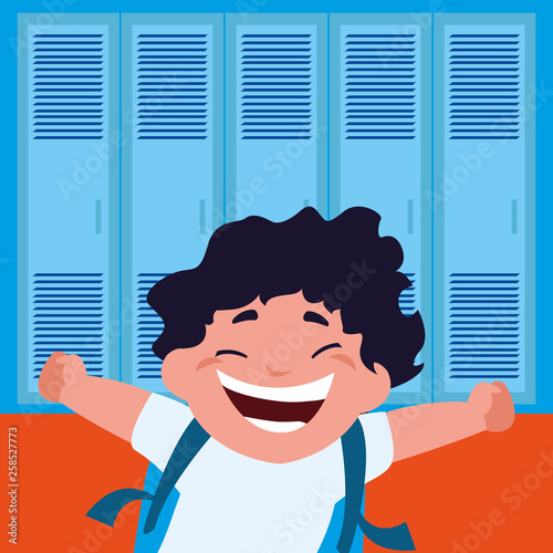 little schoolboy with schoolbag in school corridor
