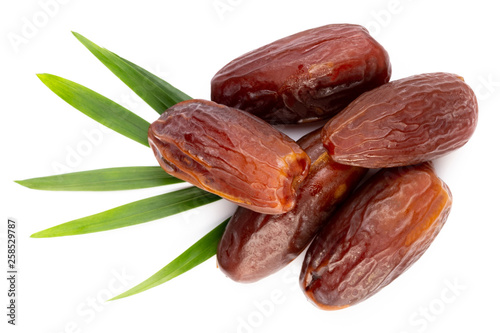 Dry dates isolated on white background. Top view. Flat lay pattern.