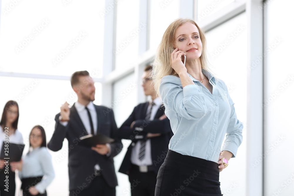 smiling business woman talking on her smartphone smiling business woman talking on her smartphone