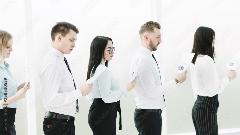 group of managers with financial reports standing in line group of managers with financial reports standing in line