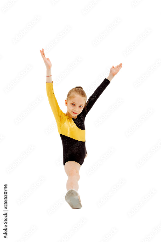 Little girl gymnast sitting in the splits. Isolated on white Little girl gymnast sitting in the splits. Isolated on white
