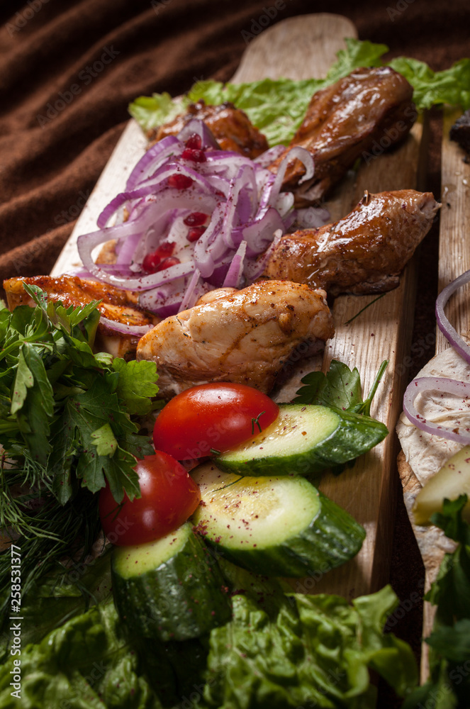 Grilled meat on a wooden Board with vegetables Grilled meat on a wooden Board with vegetables