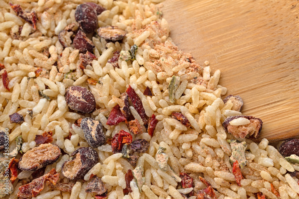 Dry Mexican rice and beans mix with a wood spoon in the food Dry Mexican rice and beans mix with a wood spoon in the food