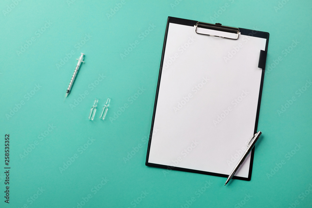 Doctors desk with tablet, pen, syringe and ampoules Doctors desk with tablet, pen, syringe and ampoules