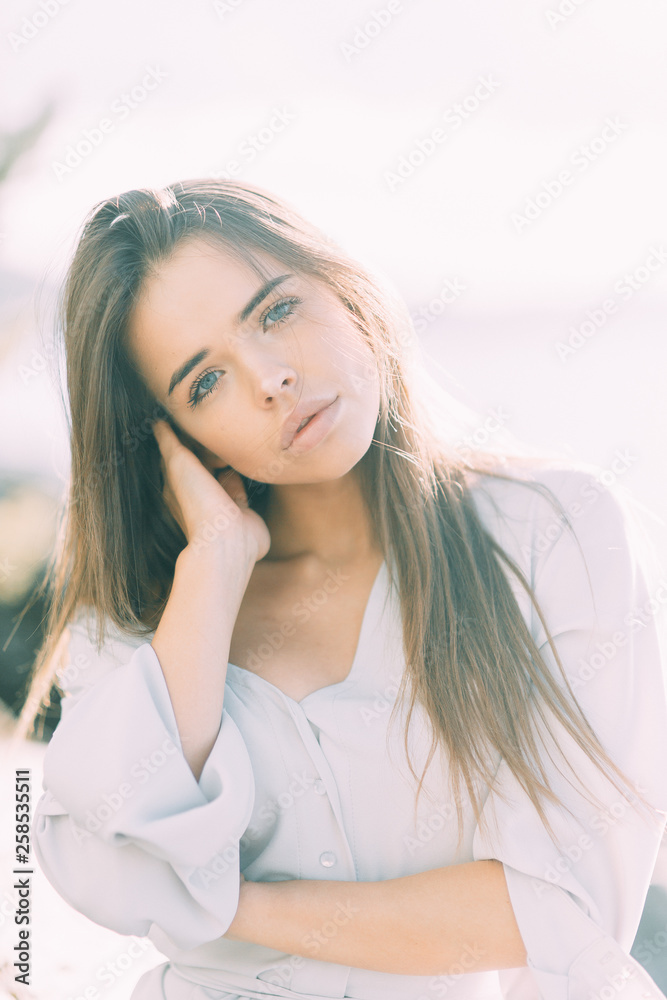 Girl in boudoir dress on the lake, standing and smiling. Unity with nature, morning bride in Russia. Beautiful eyes and model appearance Girl in boudoir dress on the lake, standing and smiling. Unity with nature, morning bride in Russia. Beautiful eyes and model appearance