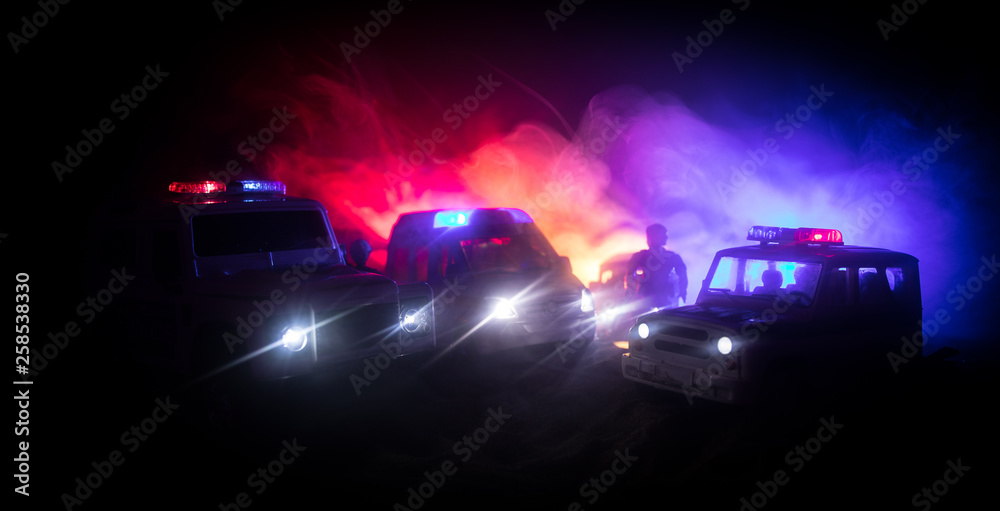 Police cars at night. Police car chasing a car at night with fog