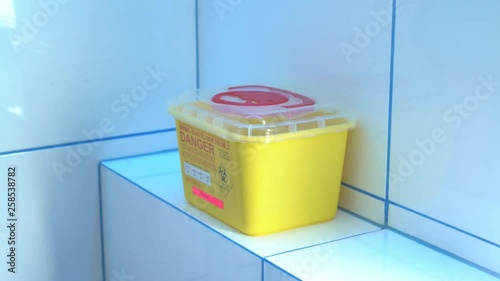 Putting a biomedical waste into a special sharps container