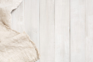 White wooden background decorated with linen napkin
