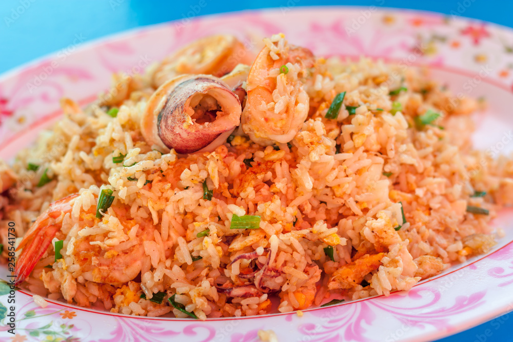 Seafood Fried rice with shrimp, squid, crab, vegetables on the dish thai style on blue table at restaurant. Thai style. Seafood Fried rice with shrimp, squid, crab, vegetables on the dish thai style on blue table at restaurant. Thai style.