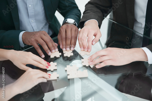 close up .multinational business team assembling puzzle.