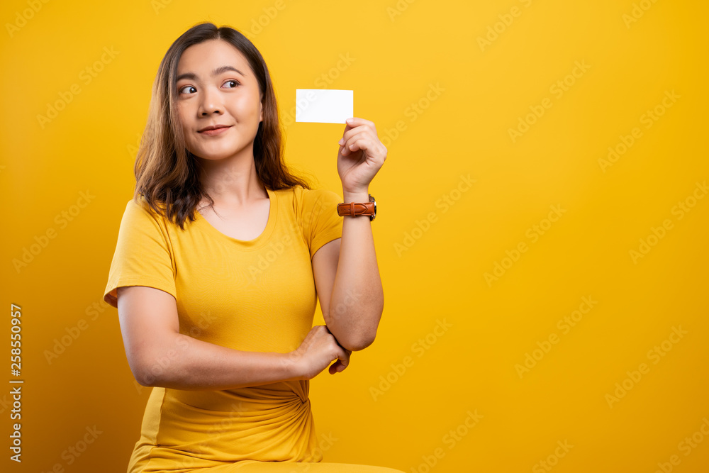 Happy woman covering face with paper card
