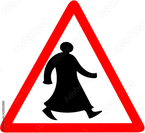 walking arab in traditional clothes tiangular road sign warning caution isolated photo