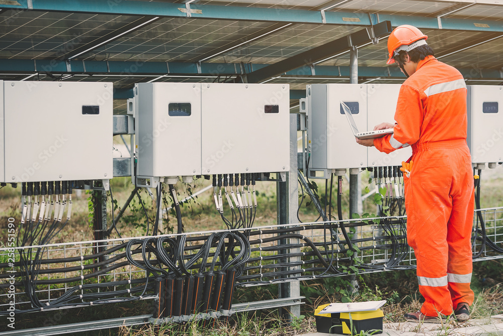 custom made wallpaper toronto digitalengineer or electrician holding laptop for inspect and checking string inverter by wifi technology ;smart technology for operate solar power plant