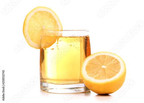 Glass jars with lemon on white background