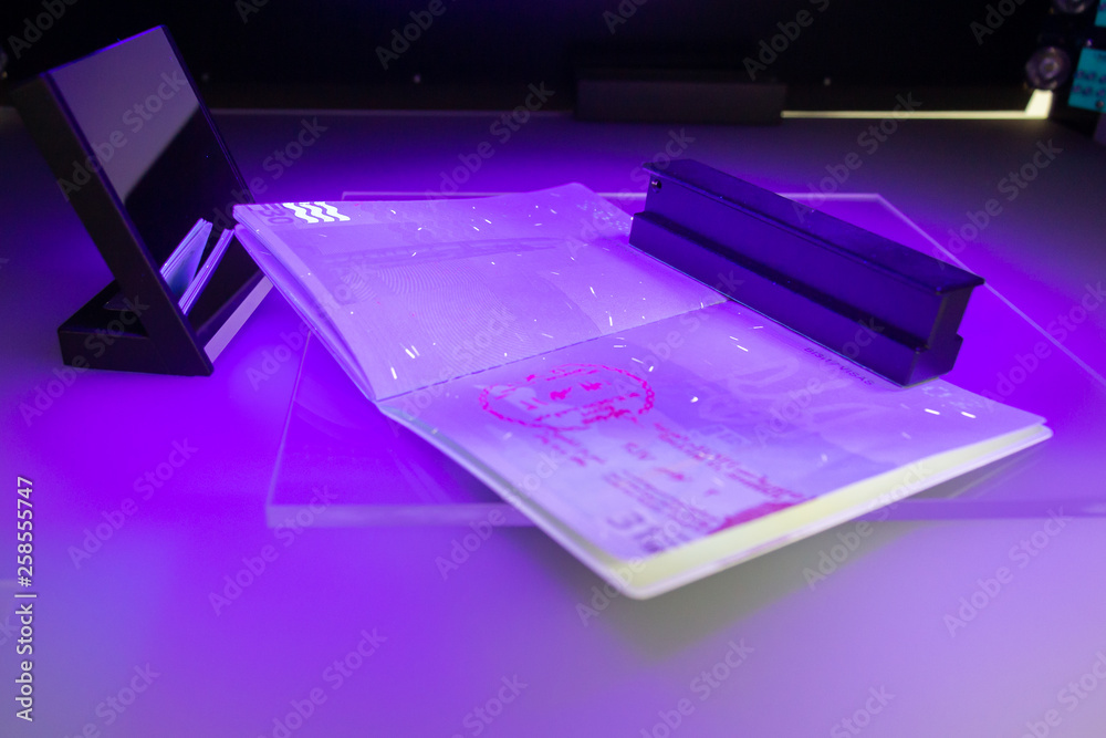 Process of the Ukrainian passport checking for fraud in ultraviolet light, the study of protective elements of the document and high security print Process of the Ukrainian passport checking for fraud in ultraviolet light, the study of protective elements of the document and high security print