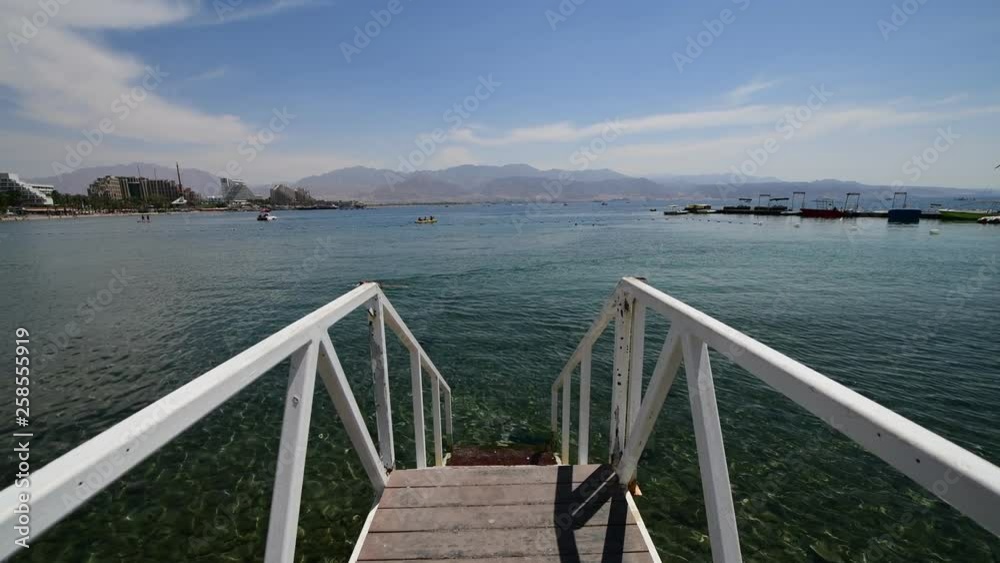 View on the Red Sea from swimming footpath on central public beach of Eilat - famous tourist resort and recreational city in Israel and Middle East View on the Red Sea from swimming footpath on central public beach of Eilat - famous tourist resort and recreational city in Israel and Middle East
