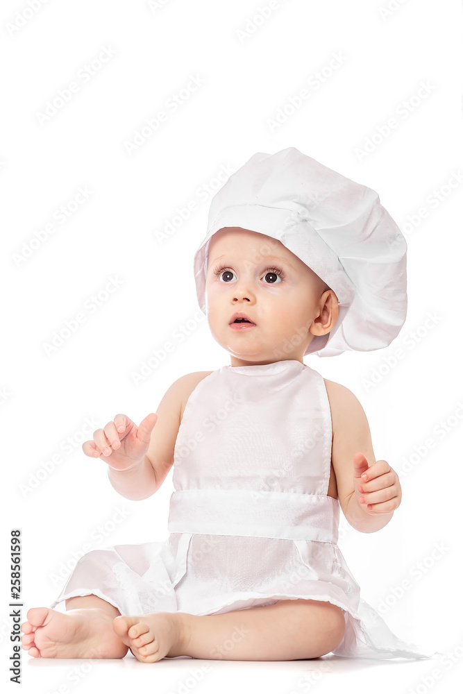 Little Chef. Adorable baby boy dressed in s chef's hat. isolated on white. Toddler playing. big size resolution. Food banner for text or design Little Chef. Adorable baby boy dressed in s chef's hat. isolated on white. Toddler playing. big size resolution. Food banner for text or design