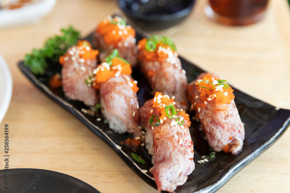 Japanese sushi food,close up of sashimi sushi set on a table in a restaurant Japanese sushi food,close up of sashimi sushi set on a table in a restaurant