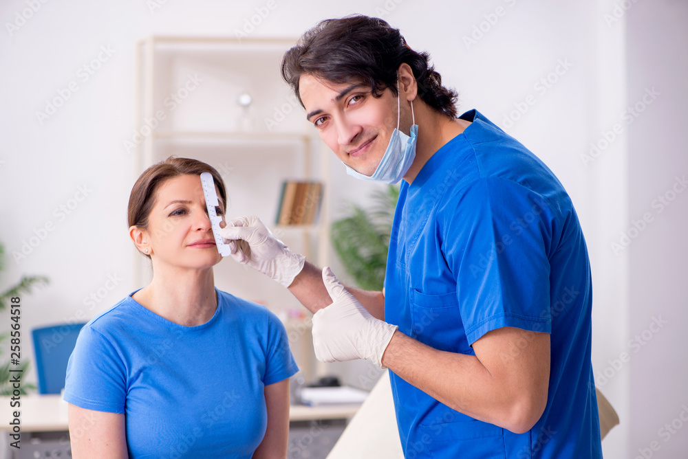 Fototapeta premium Woman visiting male doctor for plastic surgery 