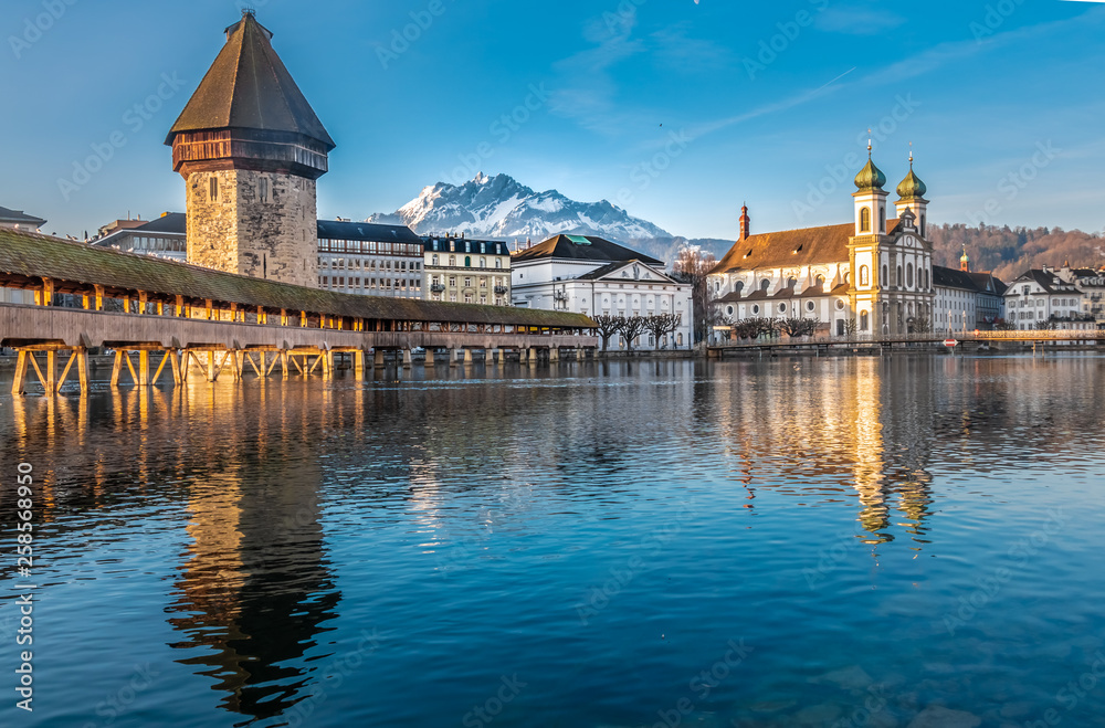 The Chapel bridge and the Jesuit Church of Lucern with Mount Pilatus in the background, Central Switzerland.