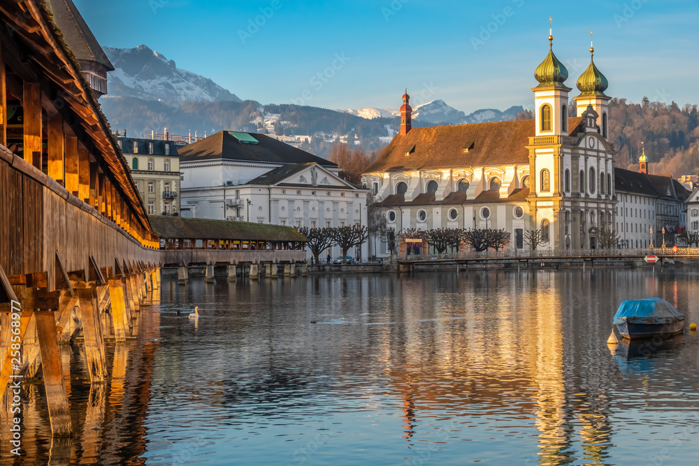 The Chapel bridge and the Jesuit Church of Lucern with Mount Pilatus in the background, Central Switzerland.