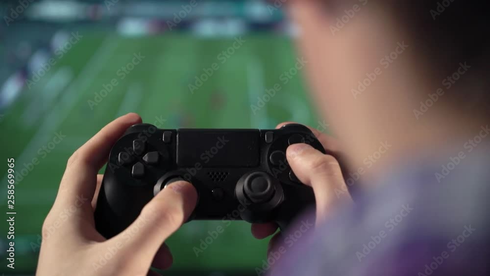 Man playing on the joystick in a game console. Man playing on the joystick in a game console.