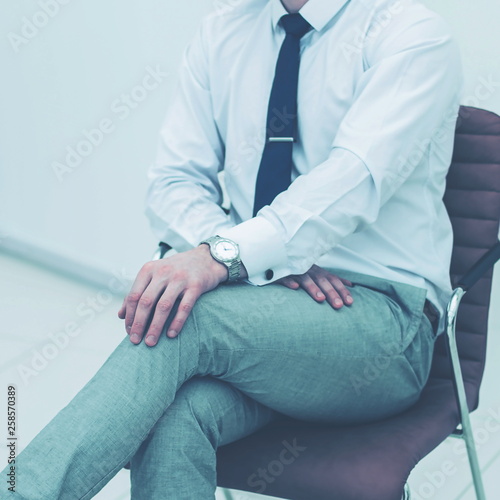 concept of business success - businessman sitting on a chair in 