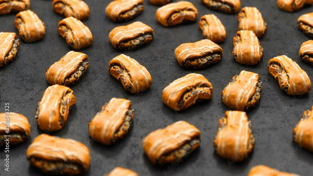 camera rotate over a variety of chocolate buns spread out on a black table camera rotate over a variety of chocolate buns spread out on a black table