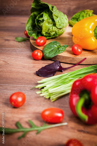 Various raw vegetables on brown wooden background